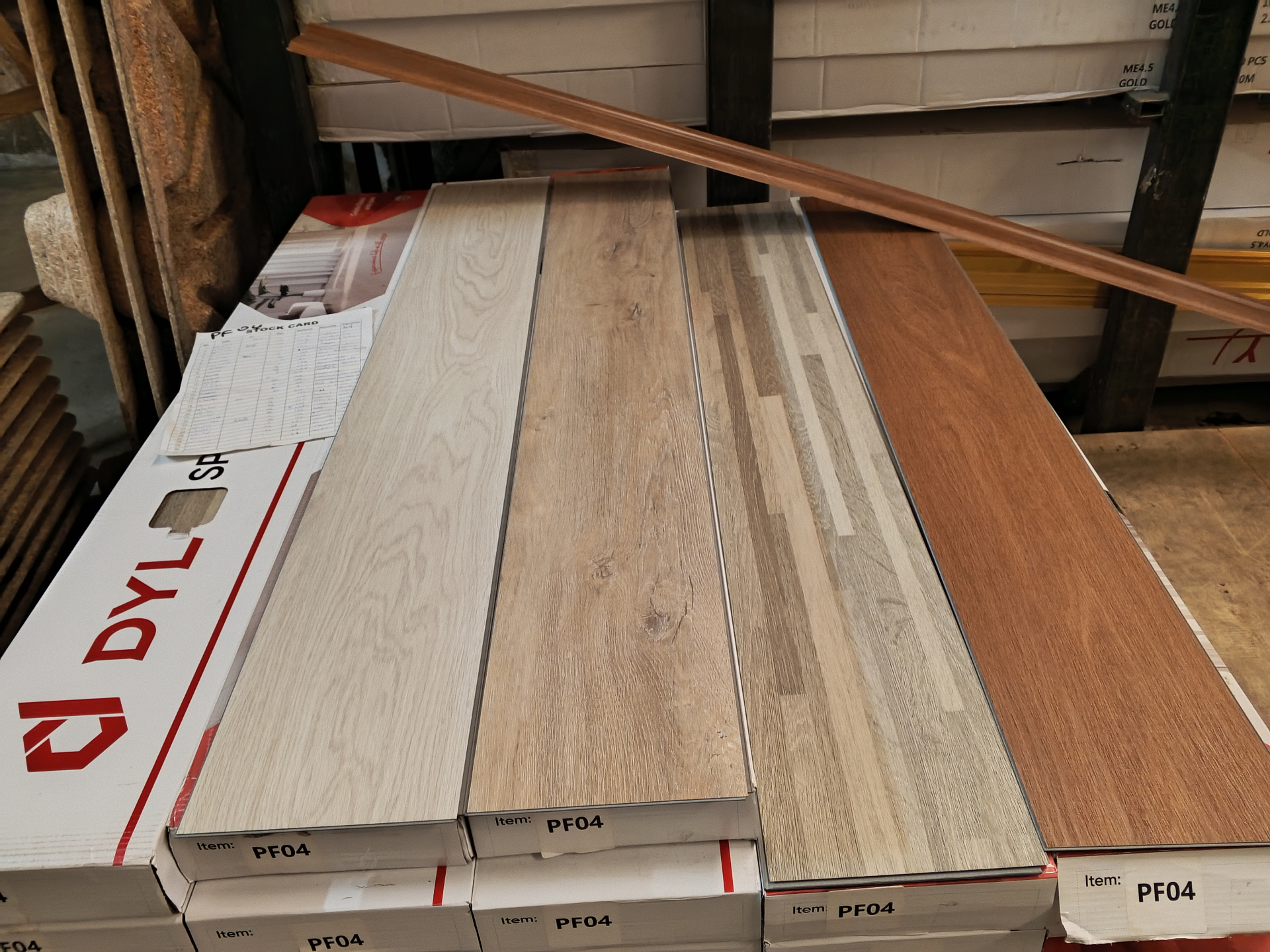 Stacked boxes of PF04 SPC planks in the warehouse