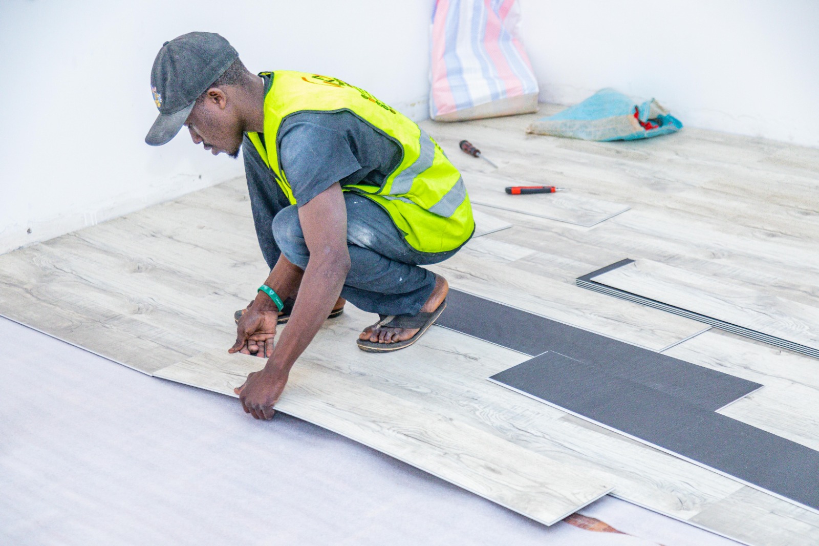 Installer clicking an SPC laminate plank into place